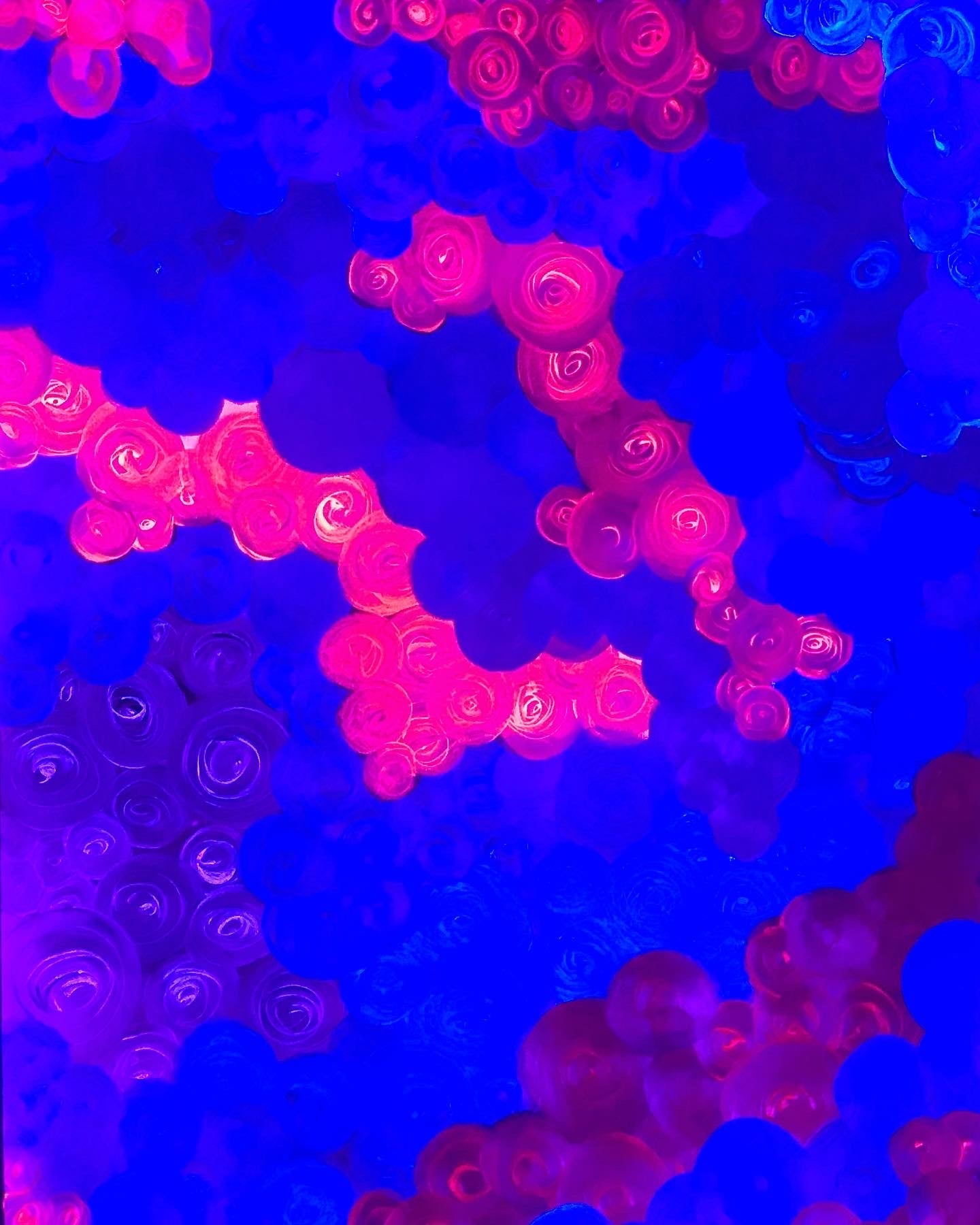 Metallic and fluorescent acrylics painting with colorful rosettes, under UV light